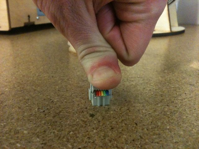 pushing down with thumb