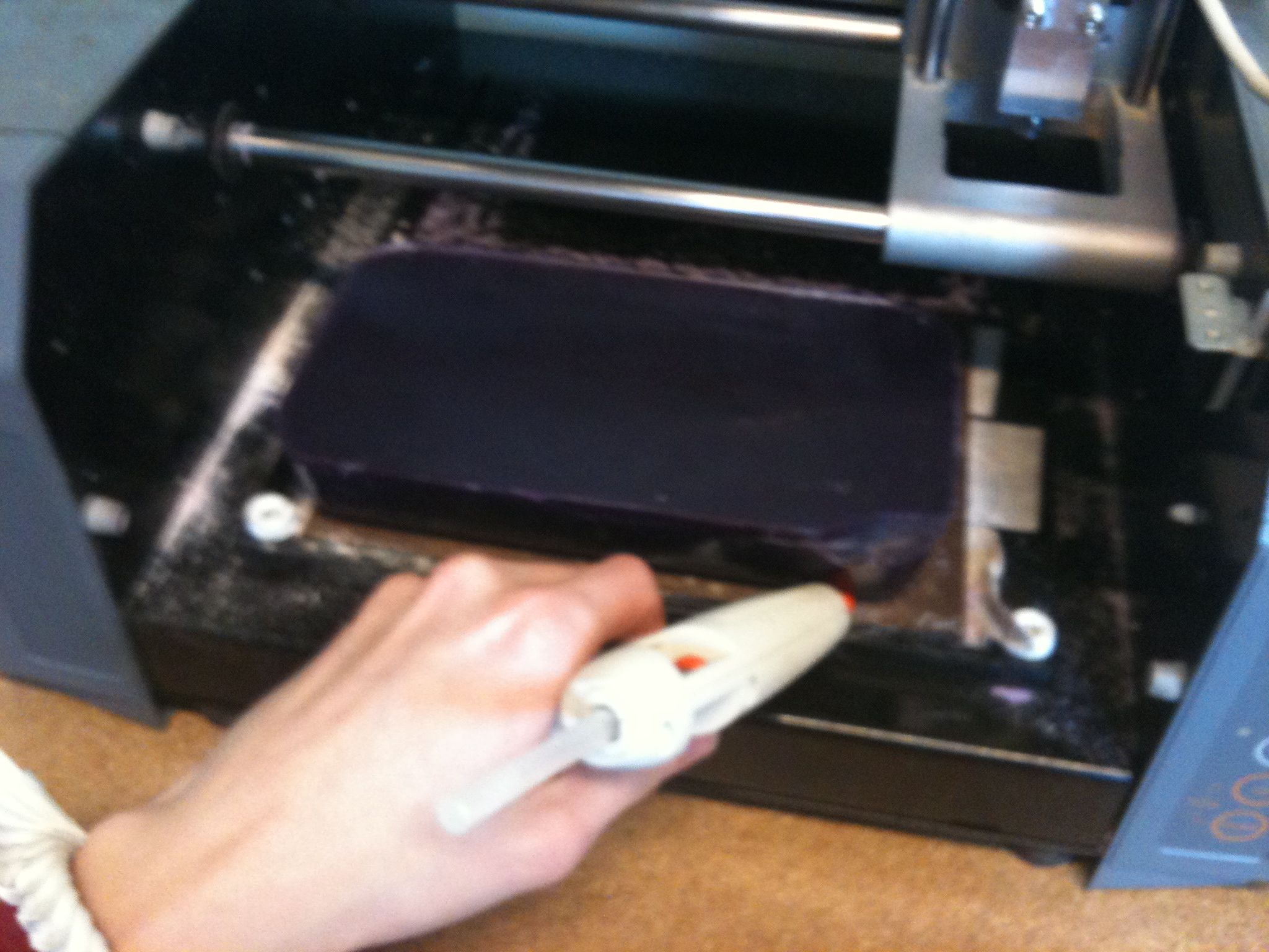 sealing it to the bed with hot glue