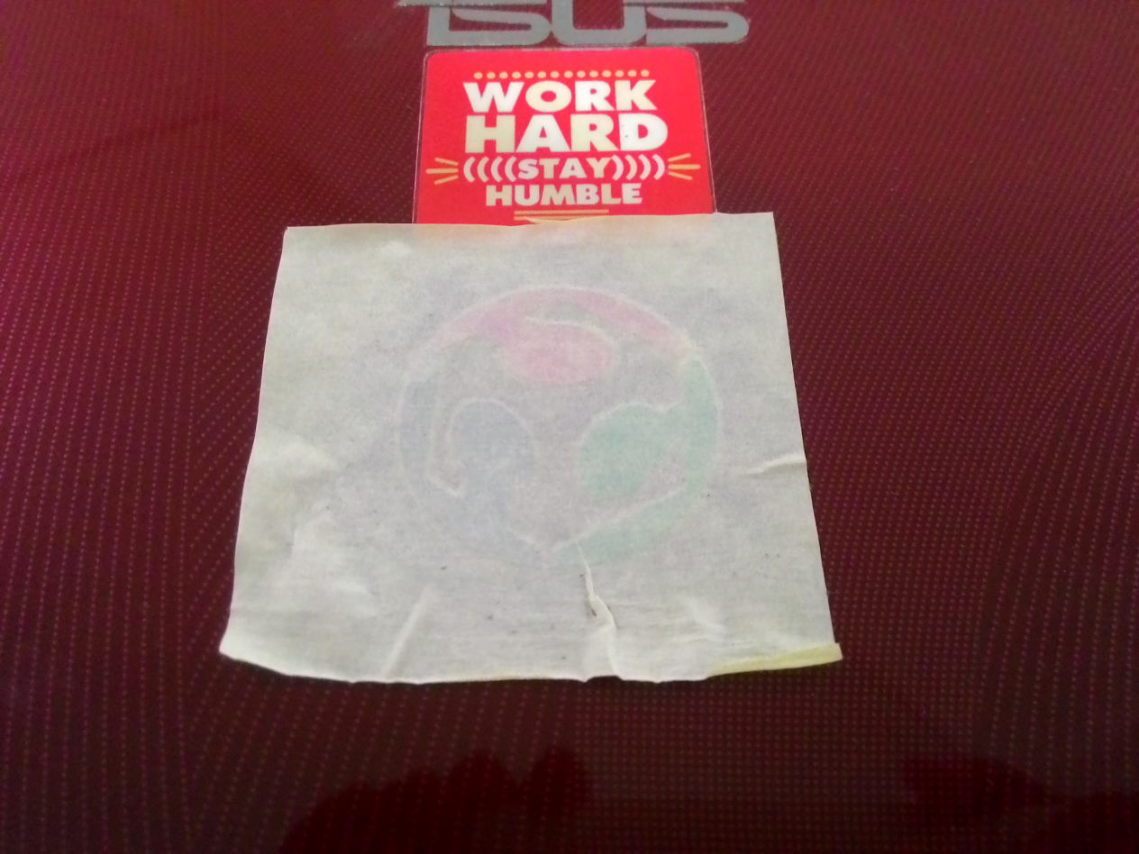 pressing sticker on laptop